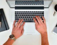 Manos sobre el teclado de un ordenador portátil